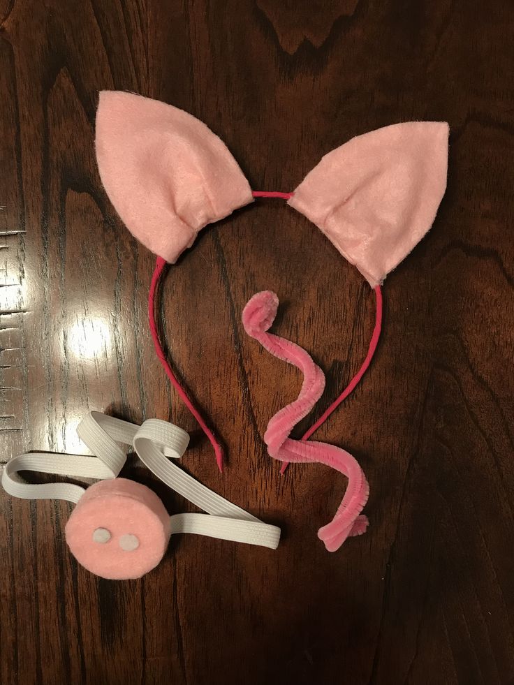 a pair of scissors and pink ears on a table