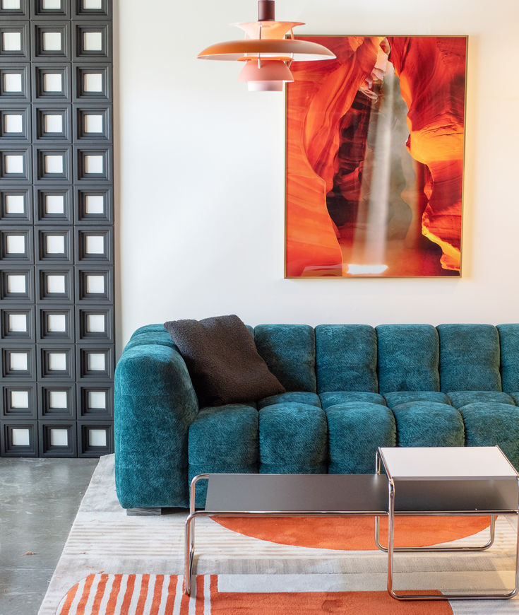 a living room with a blue couch and coffee table