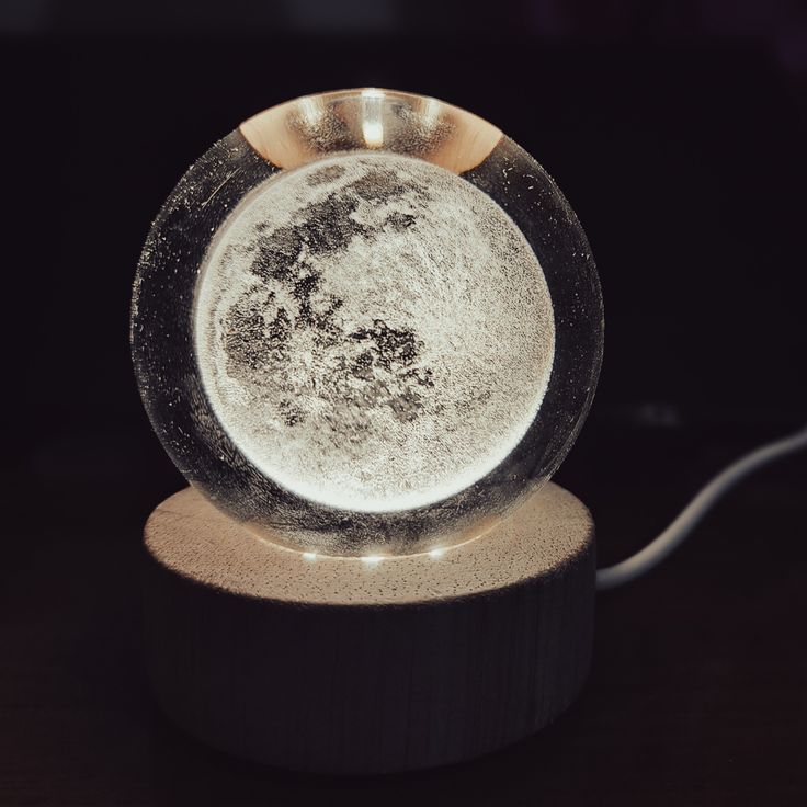 a glass ball sitting on top of a wooden stand