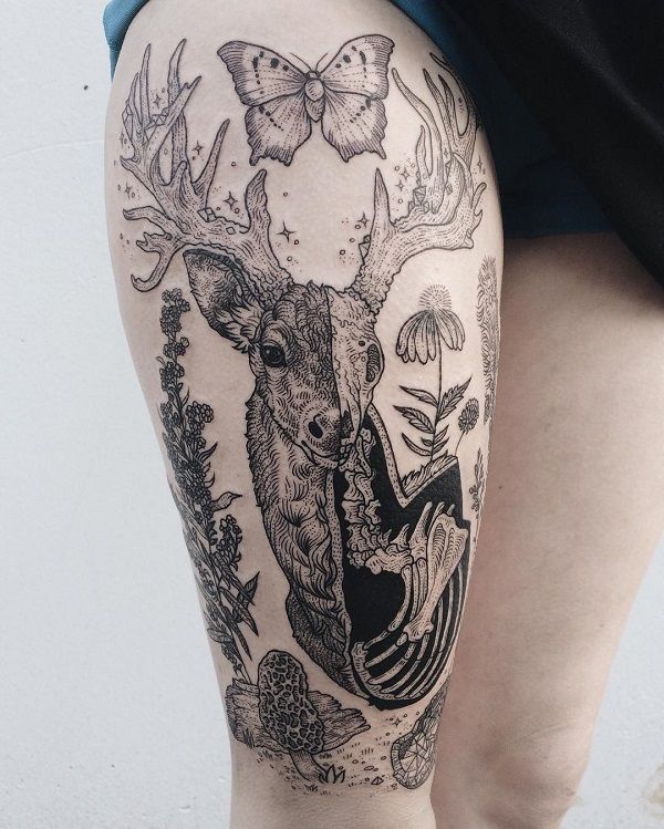 a woman's thigh with an animal tattoo on the side and butterflies flying above her