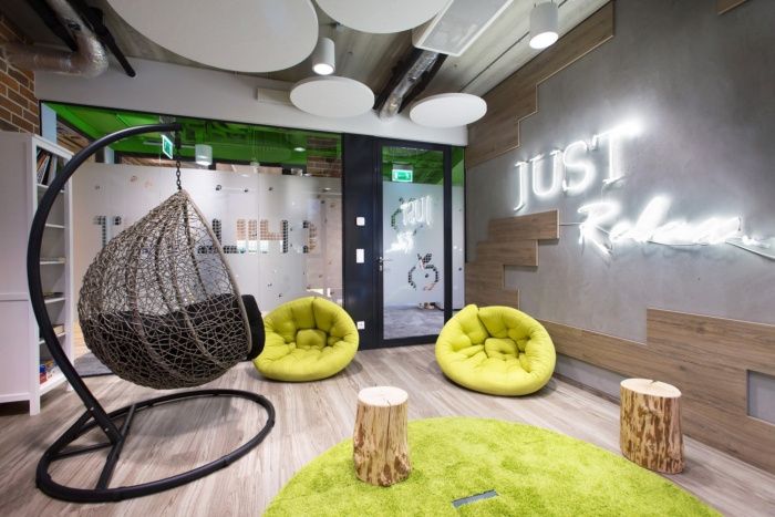 the interior of a modern office with hanging chairs