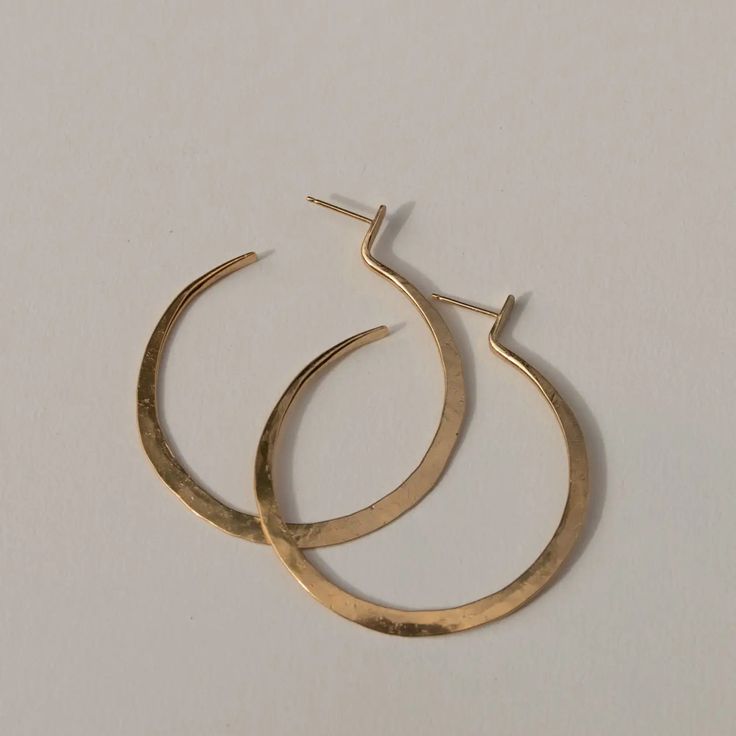 Handcrafted from brass and sterling silver posts coated in a luxuriously thick layer of 14k recycled gold. "Lenga" means "Create" in Tumbuka, the language of Northern Malawi. Dimensions: 2"L IMPACT YOUR HOME. EMPOWER COMMUNITIES. Handmade and ethically sourced in Malawi, Africa. Due to the handmade nature of this product, slight variations and imperfections may be present. S&Co strives to empower women and communities through dignified, consistent employment and reinvests 100% of the net proceed Tarnish Resistant Small Hoop Jewelry In Recycled Gold, Modern Gold Hammered Hoop Earrings, Everyday Hoop Jewelry In Recycled Gold, Everyday Recycled Gold Hoop Jewelry, Handmade 14k Gold Earrings For Everyday, Gold Sterling Silver Open Circle Earrings, Gold Open Circle Sterling Silver Earrings, Nickel-free Gold Open Circle Jewelry, Modern Hammered Huggie Jewelry