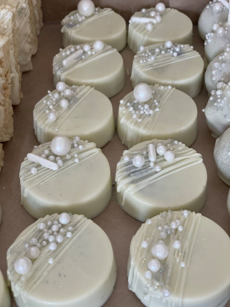 many different types of soaps are on display in a box with white frosting