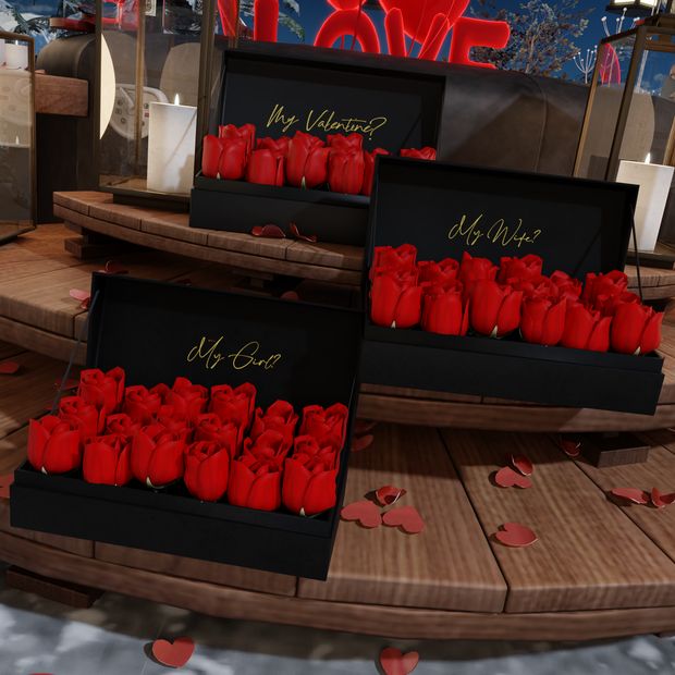 three boxes filled with red candles sitting on top of a wooden floor next to each other