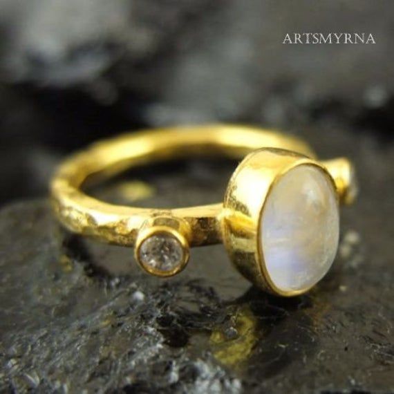 ARTSMYRNA METAL: 925k Silver GEM: Natural Moonstone COATING: 24k gold over (We can made a special type of coating for your personal preference ) MATERIEL : 925K Sterling Silver ( Some of my items vermeil gold over silver for looks rich . But i can finish in silver too ) RING SIZE: 6 (your desired size is made) SPECIAL ORDER IS MADE. If you send us a photo of your desired model (you can send your gem.) We can do it for you. We can make any design you want with natural gem. YOU JUST WANT IT ,WE DO Handmade Gold Moonstone Ring For Anniversary, Unique Gold Rings With Halo Setting, Gold Moonstone Ring With Stone Setting For Wedding, Gold Moonstone Wedding Ring, Handmade 14k Gold Moonstone Ring For Anniversary, Gold Moonstone Wedding Ring With Stone Setting, Handmade Gold Moonstone Ring In Sterling Silver, Handmade Yellow Gold Moonstone Ring For Anniversary, Handmade Gold Moonstone Ring For Wedding