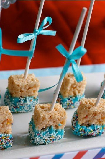 baby shower treats on a plate with blue and white sprinkles tied to them