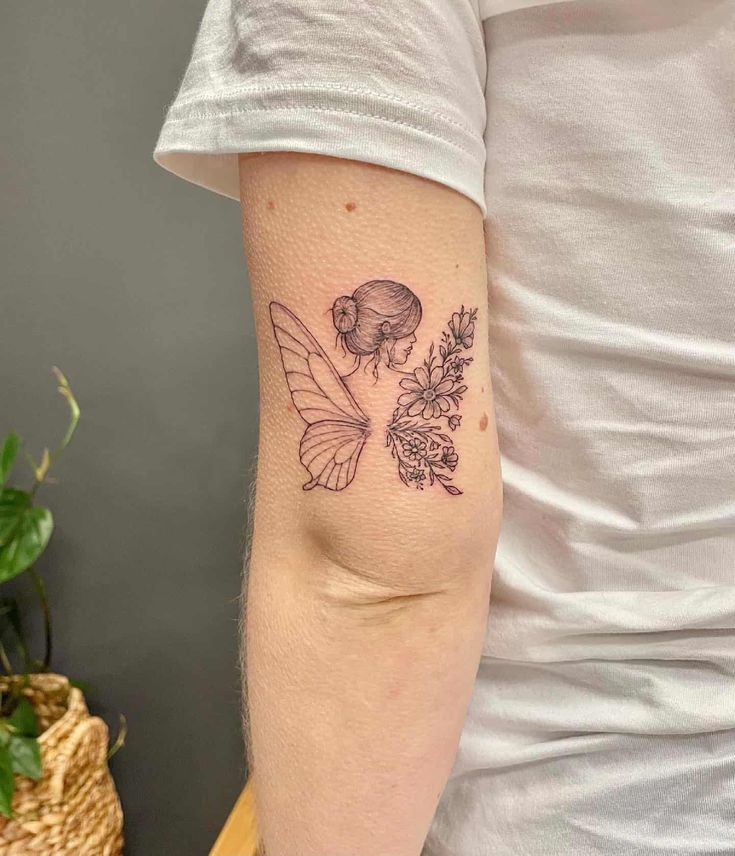 a person with a tattoo on their arm holding a flower and a bee in it