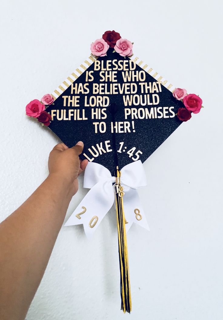 a hand holding a graduation cap that says, blessing is she who has been loved that the lord would fulfill his proms