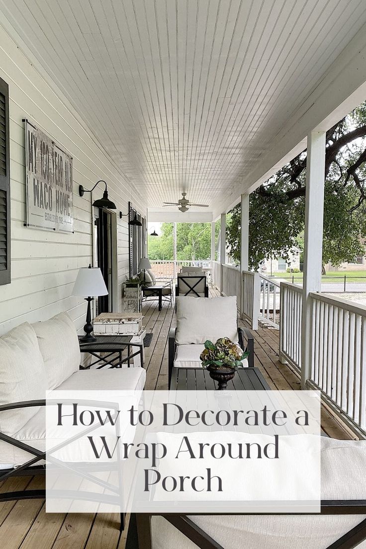 a porch with white furniture and wood flooring on the front porch, which is decorated in black and white