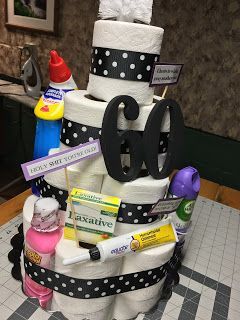 a diaper cake made to look like it has the number 80 on it and is decorated with baby items