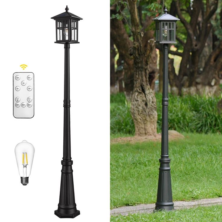 an outdoor lamp post with remote controls on the side and in front of it, next to a tree