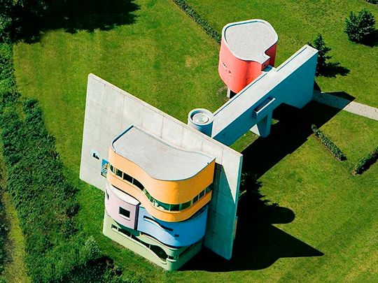 an aerial view of a building in the middle of a field