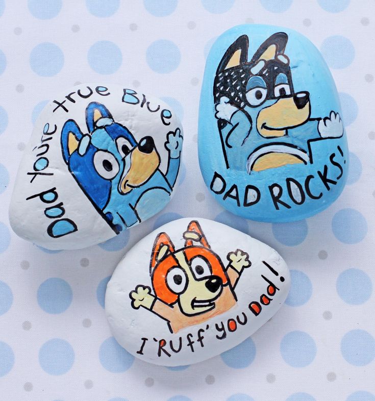 three painted rocks with cartoon characters on them