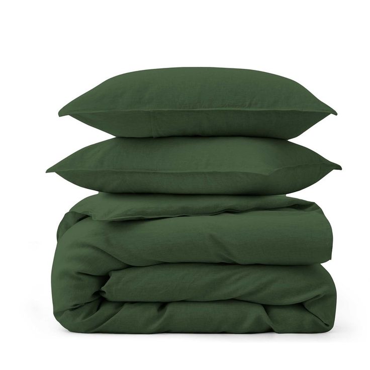 three pillows stacked on top of each other in dark green color, with the covers folded down