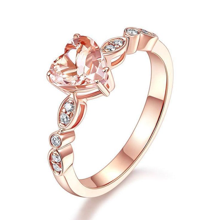 a rose cut morganite engagement ring with diamonds on the band and an oval shaped center stone