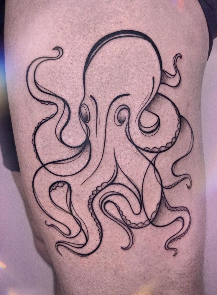 an octopus tattoo on the back of a man's thigh, with black ink