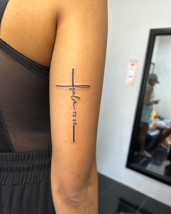 a woman with a cross tattoo on her arm