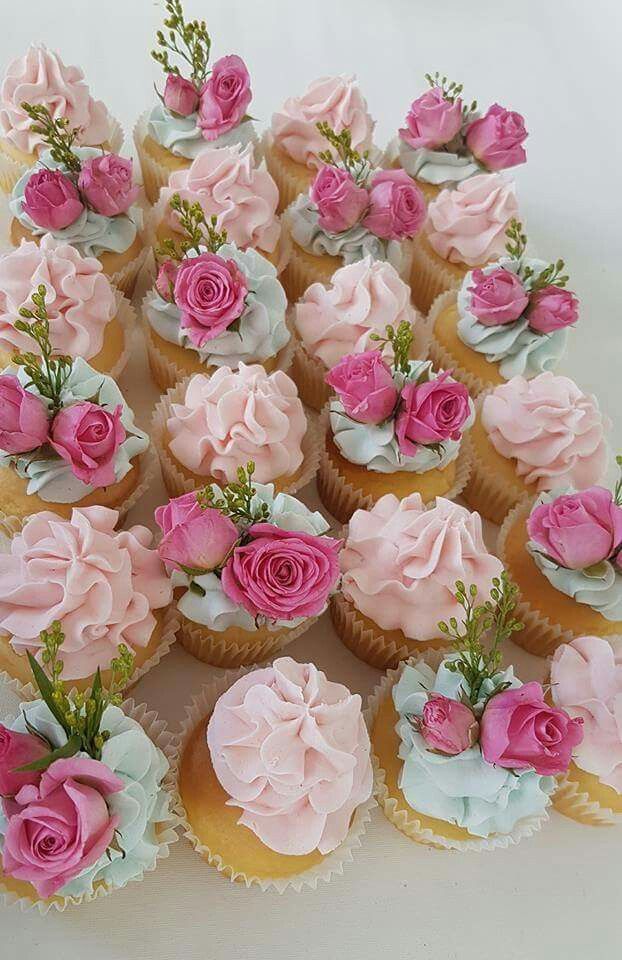 a bunch of cupcakes that are decorated with flowers