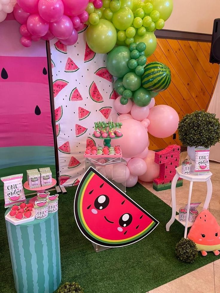 a watermelon themed birthday party with balloons