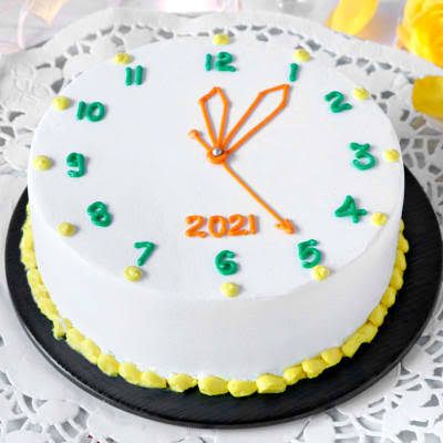 a white cake with yellow and green decorations