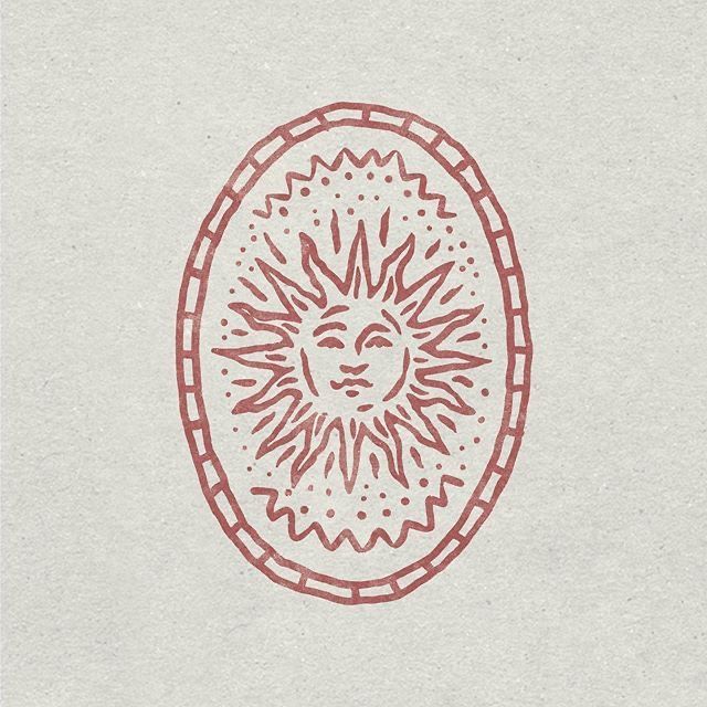 a drawing of a sun in the middle of a circle with red lines on it