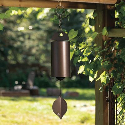 a wind chime hanging from a wooden arbor