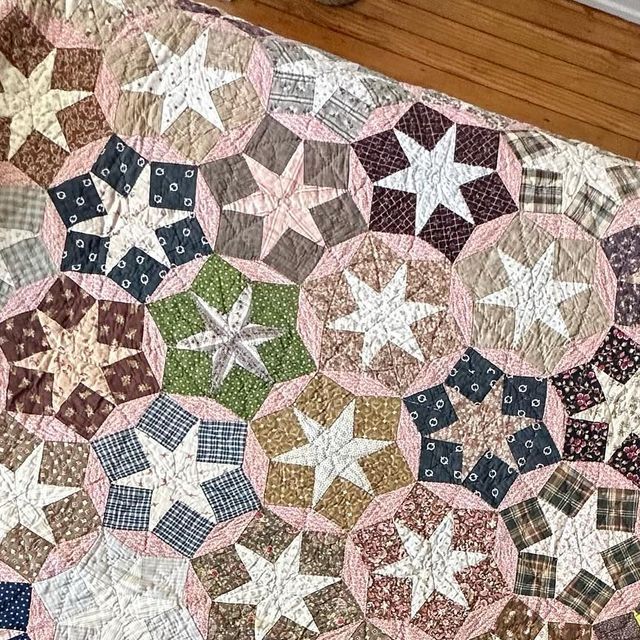 a close up of a quilt on a wooden floor