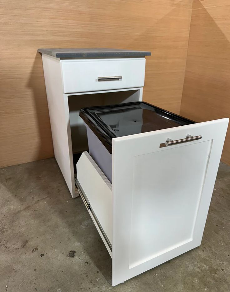 a white and black stove top oven sitting inside of a kitchen