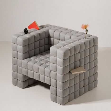 a chair made out of blocks with a book on it and a flower in the middle