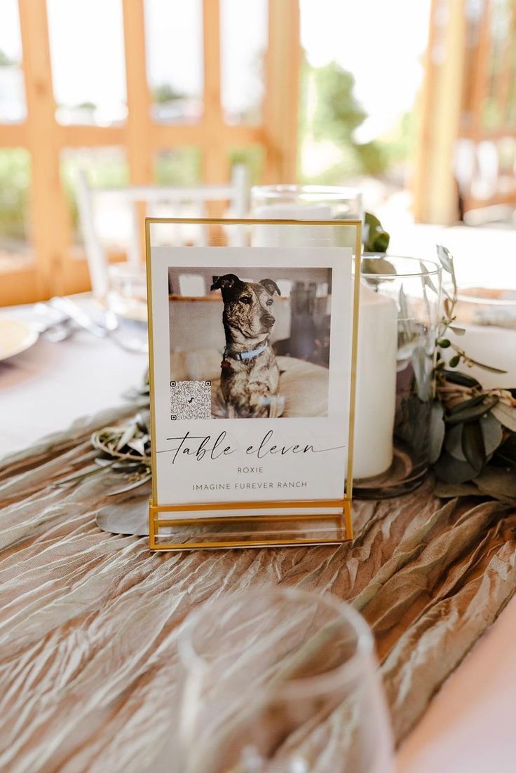 a table topped with a card next to a candle