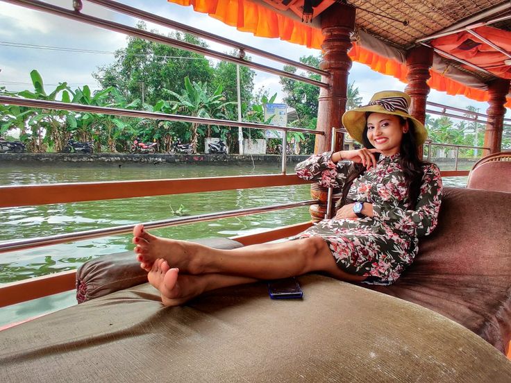 a woman sitting on top of a wooden boat