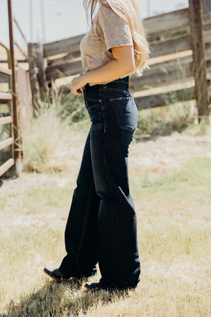 Get ready to rock a vintage-inspired, western look with Ariat's Jasmine Tomboy Jeans! Made with non-stretch dark wash denim, these jeans fit snugly through the hip and feature an ultra high rise for a flattering silhouette. The relaxed fit widens to a 25 1/2" leg opening, giving you a tomboy wide leg style. With a 12" front rise and a 33" inseam, these jeans are perfect for a stylish and casual day out. Saddle up, cowgirl! Courtney is wearing size 25 Tomboy Jeans, Western Look, Wide Jeans, Curvy Dress, Rock A, Dark Wash Denim, Bottoms Pants, Jeans Fit, Clothes For Sale