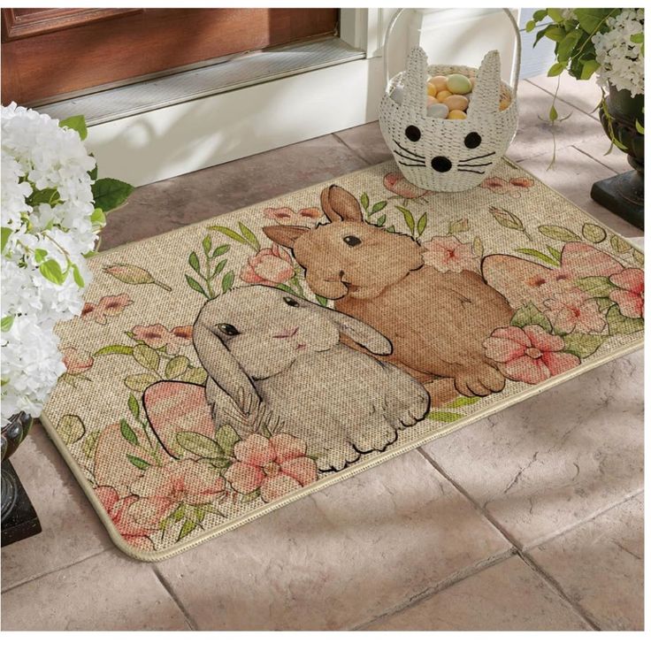 a door mat with an image of two rabbits on it and flowers in the background