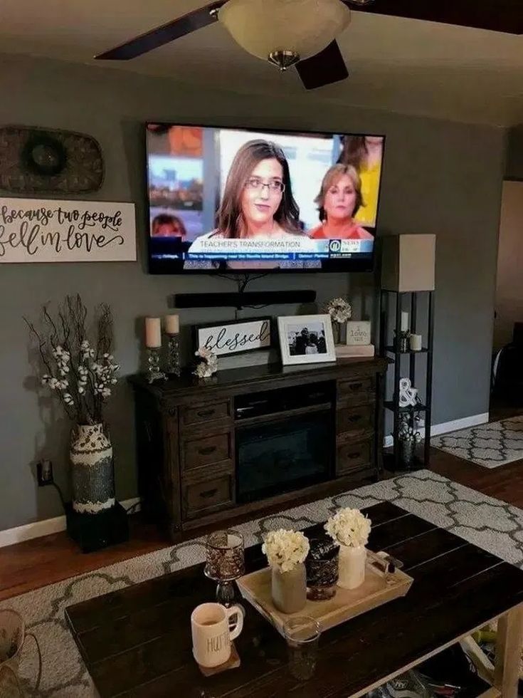 a flat screen tv mounted to the side of a wall above a wooden coffee table