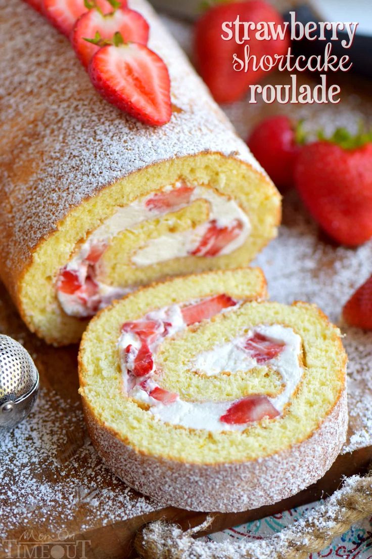 strawberry shortcake roulade with powdered sugar and strawberries on the side