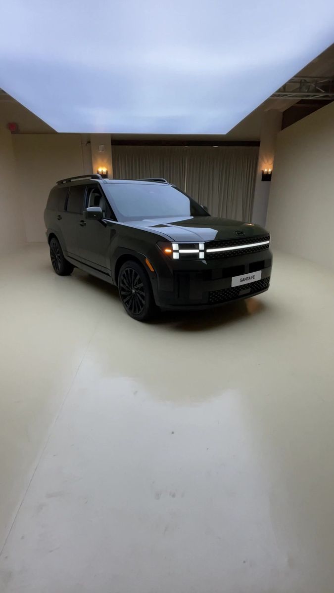 a black suv is parked in an empty garage