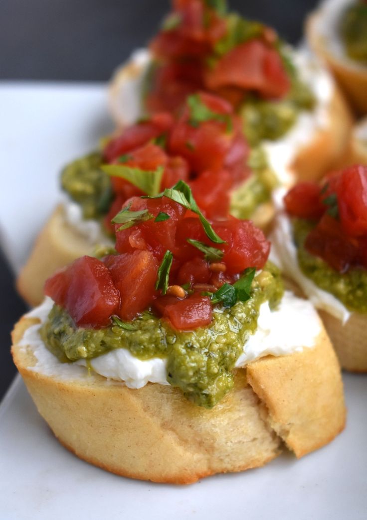 small appetizers with tomatoes and cream cheese on bread