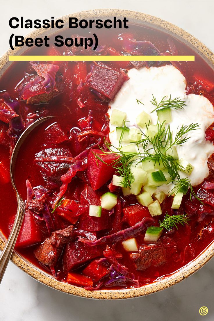 a bowl filled with beef and vegetables next to a spoon