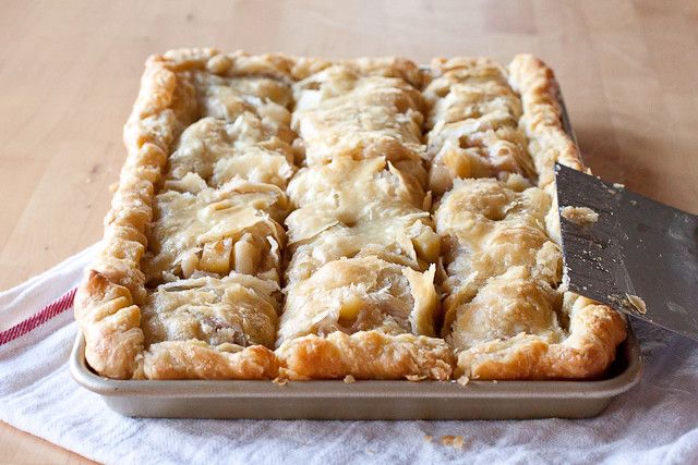 an apple slab pie with a knife in it