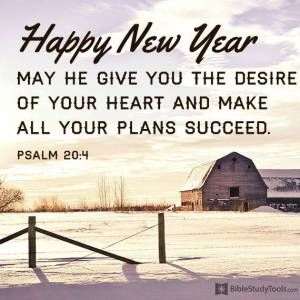 a happy new year message with a barn in the background and snow on the ground