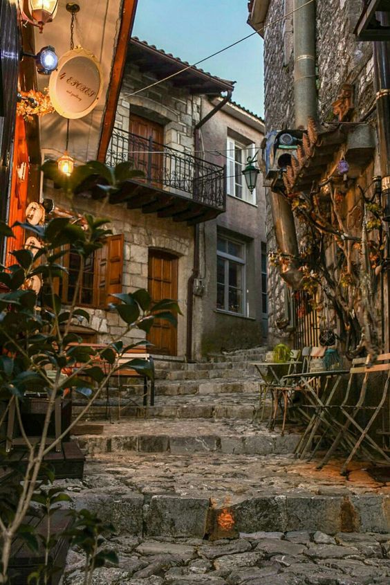 an alleyway with stone steps leading up and down