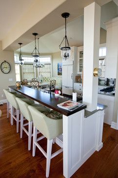 a kitchen with an island and lots of counter space next to the dining room table