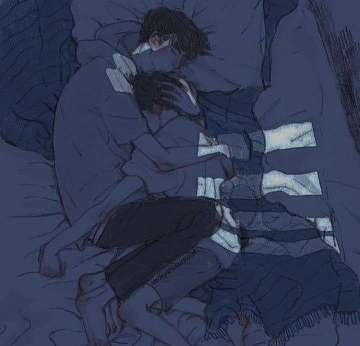 two people laying in bed with their arms around each other