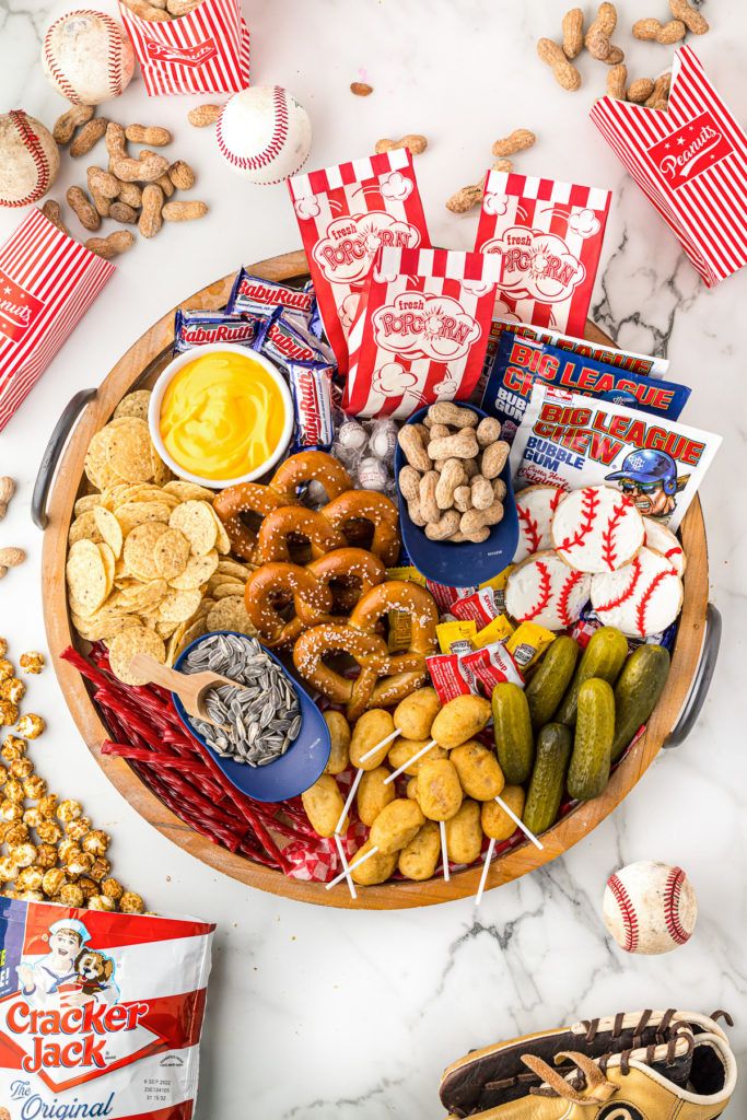 a baseball themed snack tray with snacks, crackers, nuts and pretzels