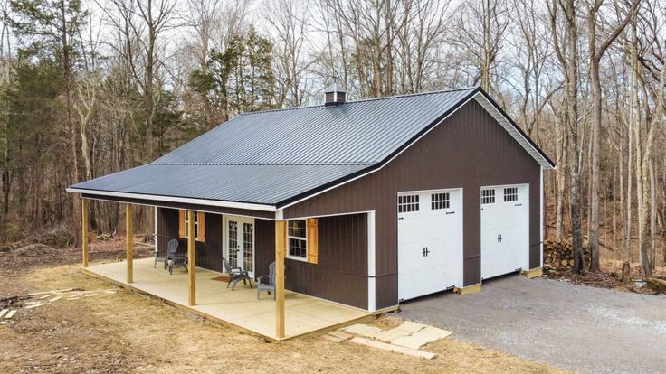 a two car garage sits in the middle of a wooded area