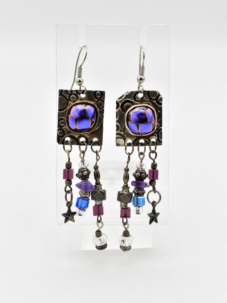 For your consideration, we are offering a unique pair of silver and art glass earrings, featuring tiny silver beads and charms. Signed LP by the maker. Weight: 14.65 grams Length: 3 1/4 inches over all Width: 3/4 inch Hallmarks: LP ** Due to USPS changes, standard shipping may take a few extra days.  If you would like a faster delivery time, we have added a new express shipping option.** Please feel free to reach out with any questions you might have about this item. **Please Note ~ The props used for photos will not be included.** We test all our vintage jewelry for karat content as well as gem testing when applicable. We use the Niton DXL Precious Metal Analyzer for metal purity, and for gem testing, we use the Presidium gem tester.  Furthermore, we tend to leave most jewelry as we recei Purple Art, The Maker, Glass Earrings, Deep Cleaning, Silver Beads, Precious Metals, Art Glass, Jewelry Earrings Dangle, 925 Silver