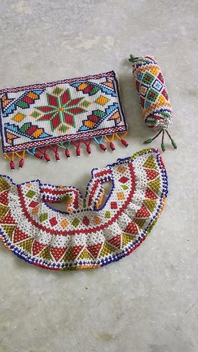 three pieces of colorful beaded fabric on the ground