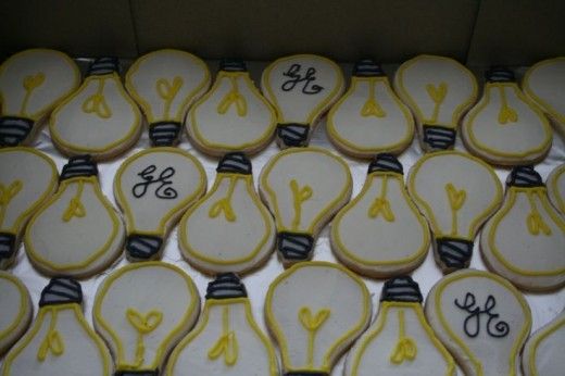 a box filled with lots of decorated lightbulb cookies