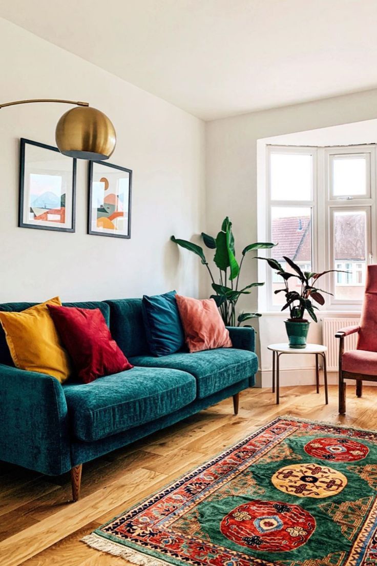 a living room filled with furniture and a rug on top of a hard wood floor