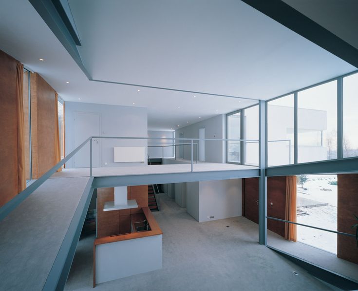 an empty room with glass walls and stairs